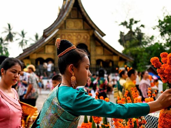 Celebração do ano novo tailandês, em Jinghong no sudoeste da província de Yunnan na China.  por STR / AFP