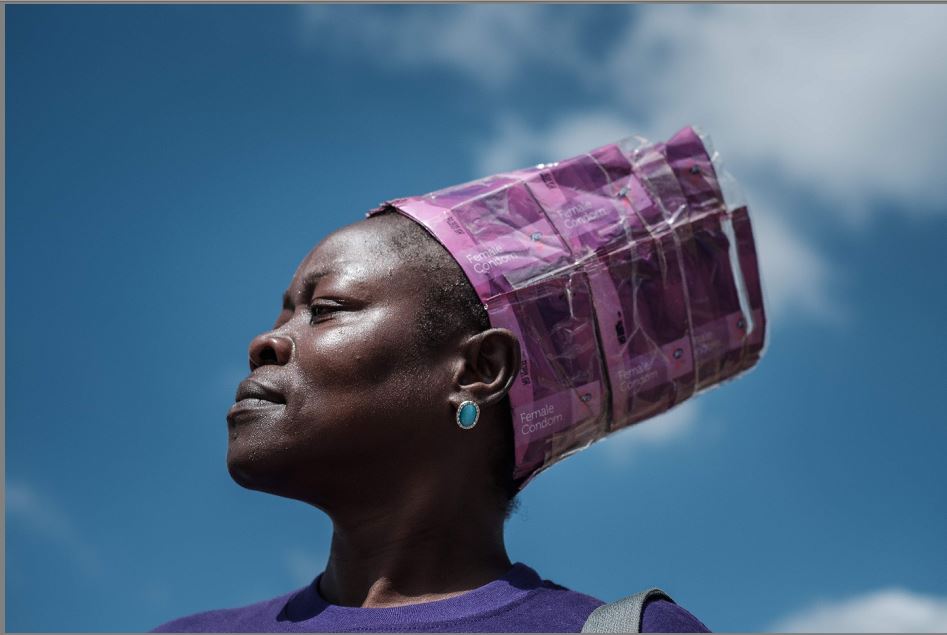 Joyce Adhiambo, ativista da prevenção contra a HIV AIDS e Tuberculose veste um turbante criado com embalagens de preservativos femininos em evento comemorativo ao Dia Mundial de Combate à AIDS na Universidade de Nairobi.  por YASUYOSHI CHIBA/AFP 