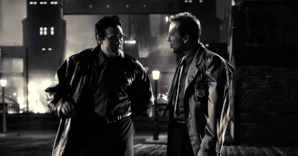 Como Bob em Sin City (2005), ao lado de Bruce Willis por Reprodução