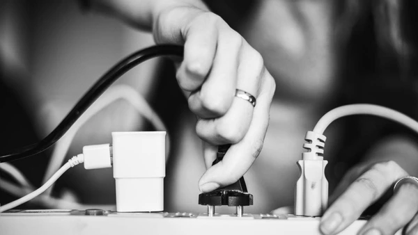 Woman plugging in a wire