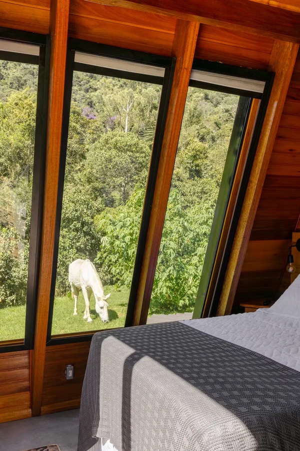 Cabana de Yanna Lavigne e Bruno Gissoni aposta em arquitetura de vidro, sauna a lenha e vista para a Serra da Mantiqueira por Manuel Sá